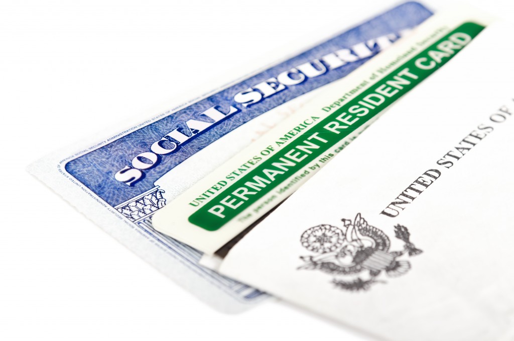 United States of America social security and green card on white background. Immigration concept. Closeup with shallow depth of field.