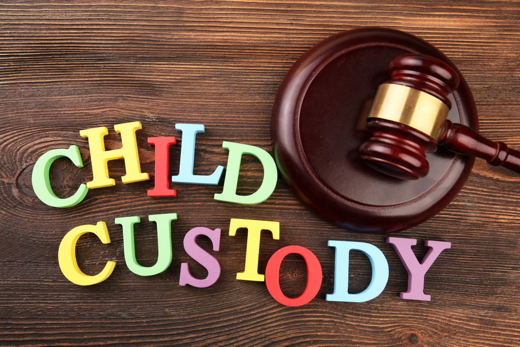 A gavel and colourful letters regarding child-custody and family-law concept