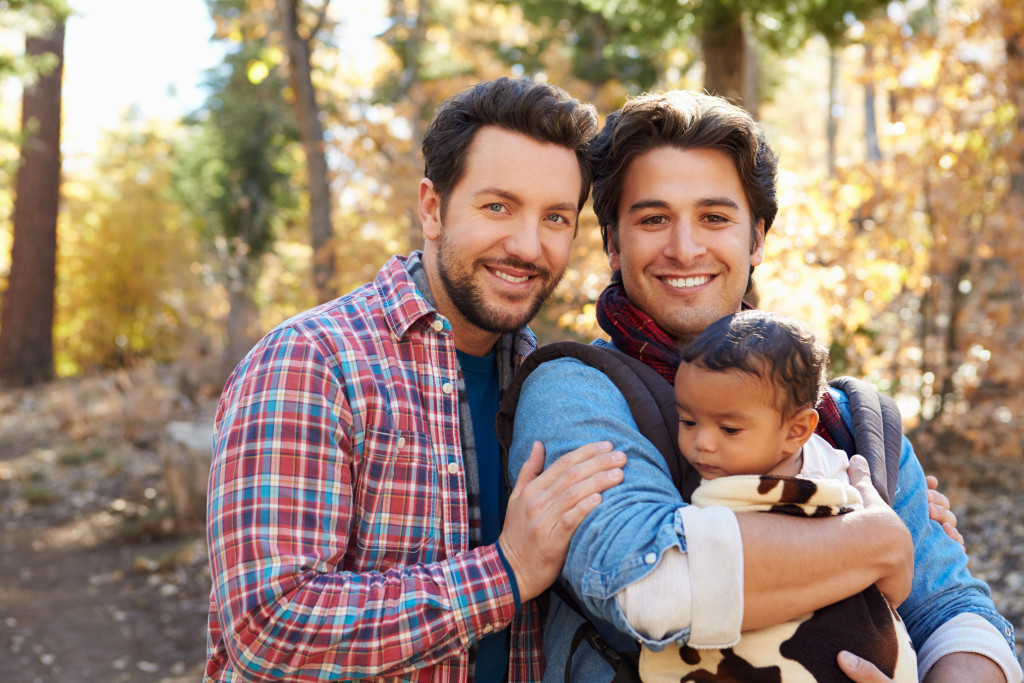 Gay couple holding a baby