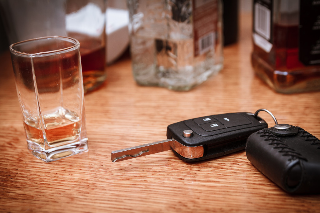 Alcohol and car keys on table